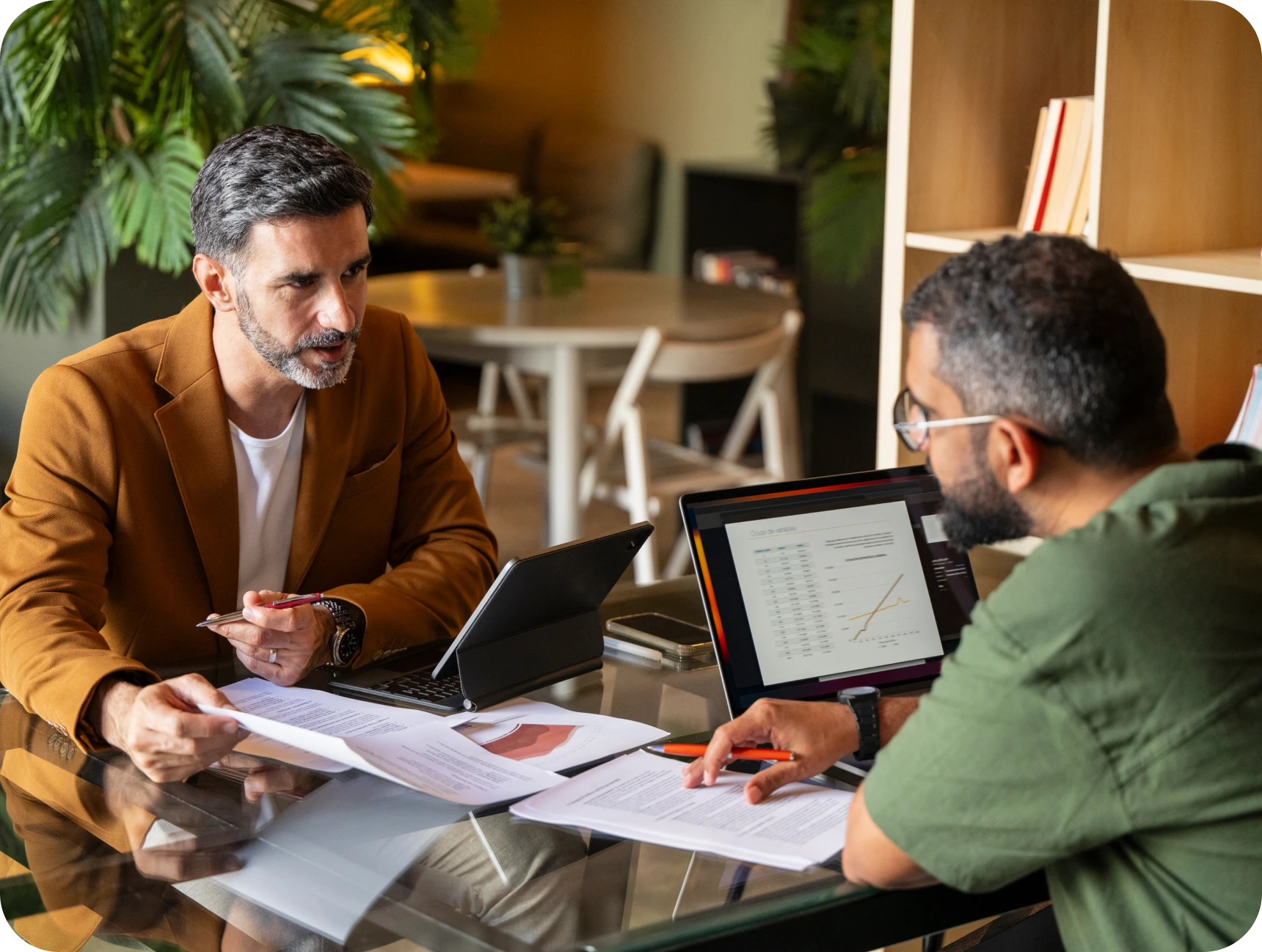 Colleagues reviewing financial reports together